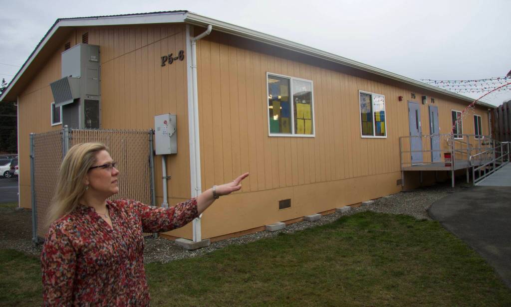 Crescent Harbor Elementary School Principal Kate Valenzuela stands in front of one of the schools eight portable classrooms. (Photo by Rachel Rosen/Whidbey News-Times)