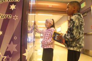 Photo by Karina Andrew/Whidbey News-Times
Cristal Hernandez Cruz, left, and Trenton Miller select books from the vending machine at Crescent Harbor Elementary School.