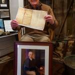 Photo by David Welton
South Whidbey Historical Society President William Haroldson proudly holds a paper copy of Whidbeys will. He has been studying Whidbeys life for the past 20 years, and even brought back a reprint of a portrait of the naval explorer from England in 2003.