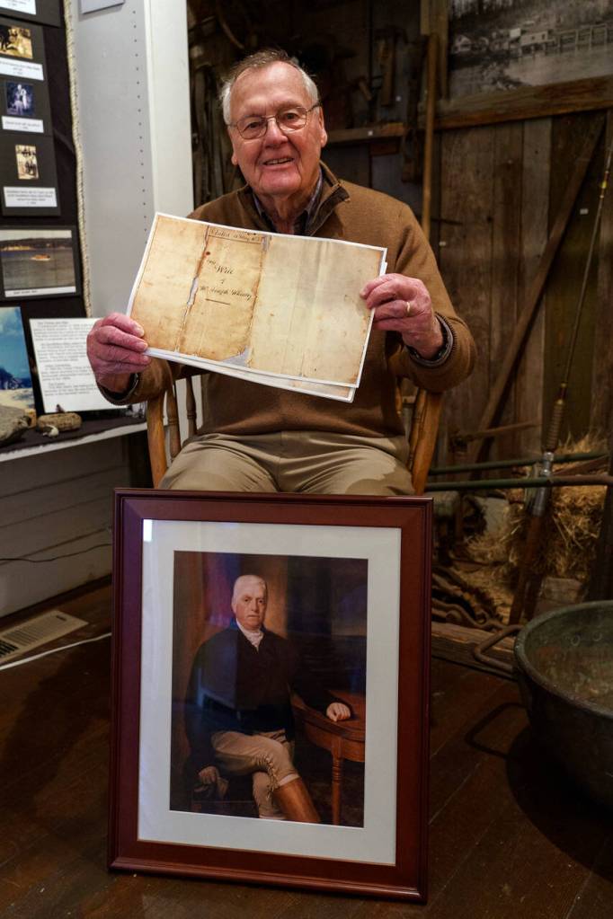 Photo by David Welton
South Whidbey Historical Society President William Haroldson proudly holds a paper copy of Whidbeys will. He has been studying Whidbeys life for the past 20 years, and even brought back a reprint of a portrait of the naval explorer from England in 2003.