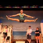 Photo by John Fisken
Kalmi Nero, who is part of the ensemble of Oak Harbor High Schools production of Mama Mia, takes a leap on stage.