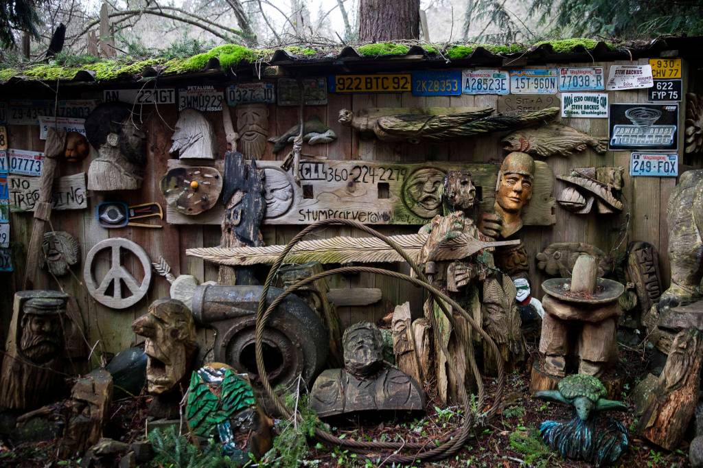 Carvings and other fixtures cover the wall and fence around the property in Clinton. (Olivia Vanni / The Herald)