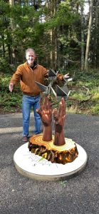 Photo provided
Scott Price, owner of Price Sculpture Forest, with the augmented reality version of the sculpture Inciting Hope, by artist Bill Baran-Mickle. The real-world sculpture is currently on display in Poulsbo, Washington.