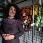 Willow Mietus, 50, stands inside The Wool Wagon. (Annie Barker / The Herald)