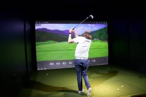 Photo by Rachel Rosen/Whidbey News-Times
Puget Sound golf Club owner Josh Ray takes a swing using the golf simulator.