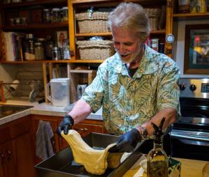 Photo by David Welton
Clinton resident and artist Louie Rochon works the dough of what will soon be focaccia bread. Baking is his newest creative outlet.