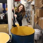 Photo provided
Michelle Scandalis scoops some honey during the mead-making process.