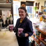 Employee Jennifer Adcock prepares two drinks.