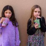 Willow Skaggs, 7, and Sapphire Simms Lamar, 8, sip drinks from TONIC Juice & Remedy.
