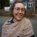 Lisa Mitchell models a shawl made from the first fleece of Alma, a young guanaco who was born on the farm. (Photo by David Welton)