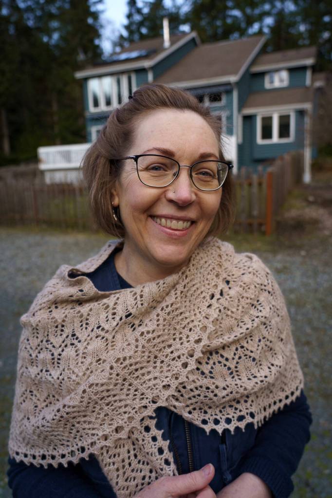 Lisa Mitchell models a shawl made from the first fleece of Alma, a young guanaco who was born on the farm. (Photo by David Welton)