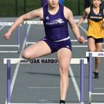 Bri Richard clears a hurdle at a March 19 track meet against Burlington. The Oak Harbor High School varsity girls team won 96.83 to 53.16. (Photo by John Fisken)