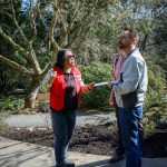 Docents Maria Cablao greets visitors in the gardens. (Photo by Cynthia Woerner)