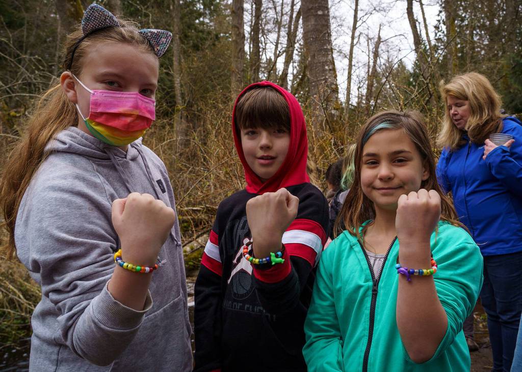 Photo by David Welton
A group of friends shows off the colorful bracelets they made that represent the life cycle of salmon.