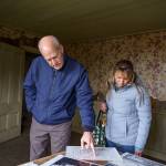 Rep. Rick Larsen and Marie Shimada look over historic photos and floor plans inside the Ferry House on Central Whidbey. (Photo by David Welton)