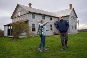 Photo by David Welton
Ebey's Landing National Historical Reserve manager Marie Shimada shows Rep. Rick Larsen around the historic Coupeville Ferry House property during a visit to the island April 6.