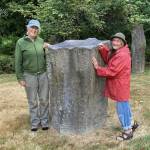 Photos provided
Cary Peterson, left, and Shanti Loustaunou with the memorial stone in 2022, which has sunk nearly a foot since its installation.