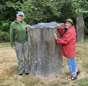 Photos provided
Cary Peterson, left, and Shanti Loustaunou with the memorial stone in 2022, which has sunk nearly a foot since its installation.