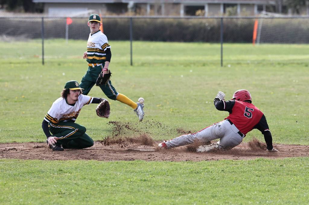 Coupeville senior Scott Hilborn slides into a base during a baseball game against visiting Darrington High School April 11. The Wolves won 10-0. (Photo by John Fisken)