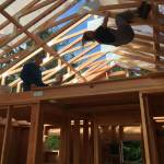 Gabbi Korrow hangs from the rafters during construction of her home. (Photo provided)