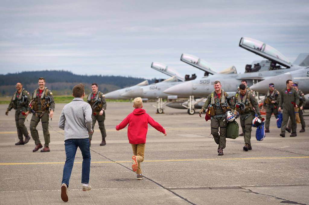 Capt. Erik Halvorsons sons greet him on the flight line as he and his squadron return home from deployment April 22.