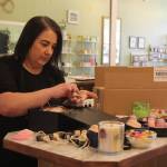 Photo by Karina Andrew/Whidbey News-Times
Megan Varner-Duckett packs a gift box with her homemade candles.