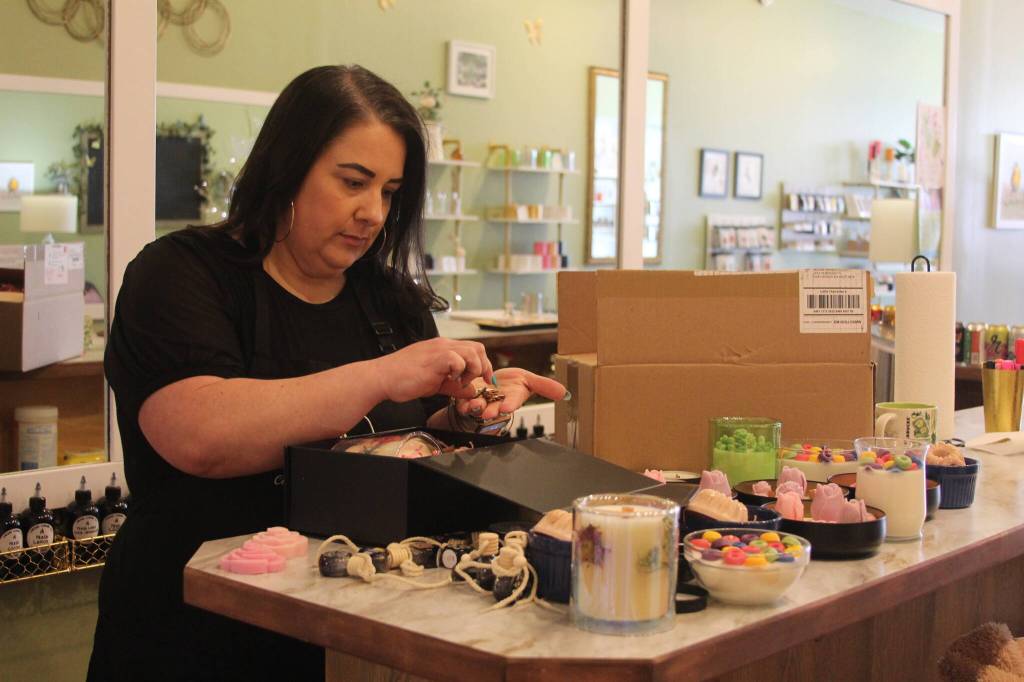Photo by Karina Andrew/Whidbey News-Times
Megan Varner-Duckett packs a gift box with her homemade candles.