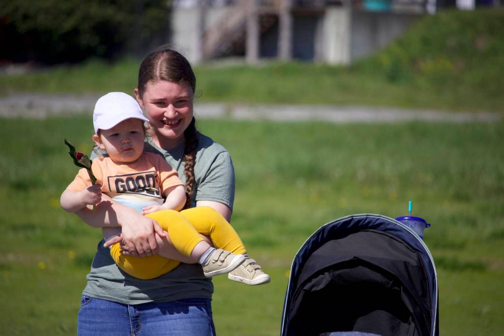 Julya Peters and her daughter Amelya watch the parade.