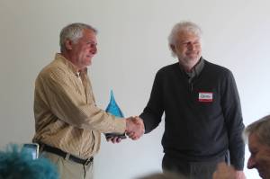 Photo by Karina Andrew/Whidbey News-Times
Joe Grogan, left, accepts the Grace Under Pressure award from state Department of Health representative Derek Pell.