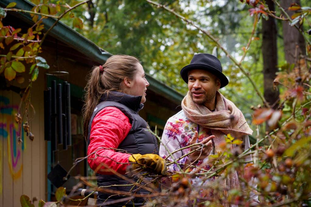 Volunteer Alexa Holmly speaks with homeowner Ian Joseph Jackson.