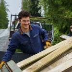 Photos by David Welton
Volunteer Kai Fletchers loads old fence boards into a trailer.