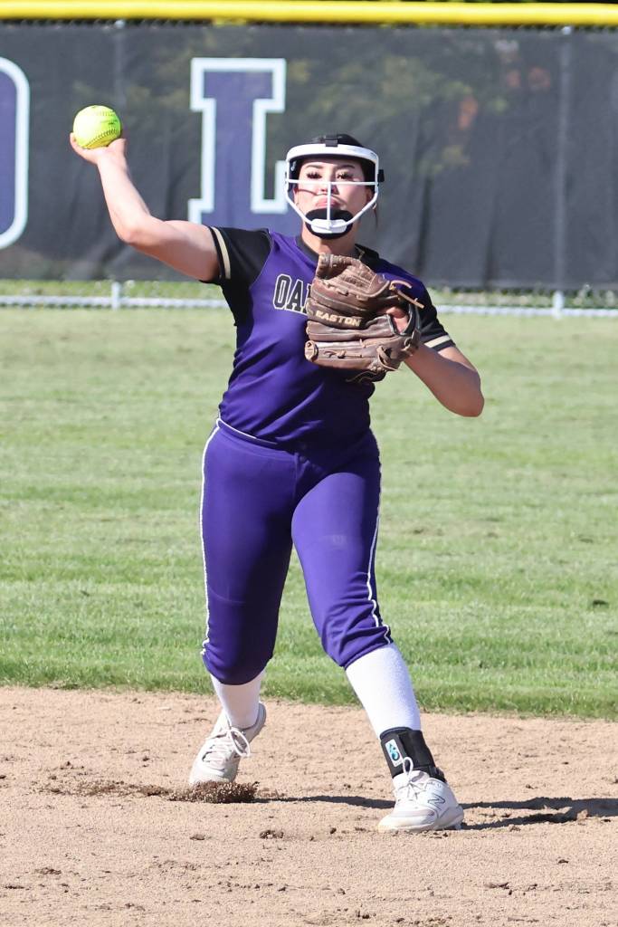 Oak Harbor athlete Desi Becherer makes a throw at a softball game against Sedro-Woolley May 9. (Photo by John Fisken)