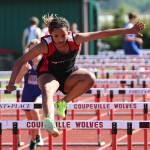 Seventh grader Arianna Cunningham leaps over a hurdle at a track meet against South Whidbey Middle School Wednesday. (Photo by John Fisken)
