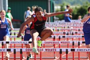 Photo by John Fisken
Seventh grader Arianna Cunningham leaps over a hurdle at a track meet against South Whidbey Middle School Wednesday.
