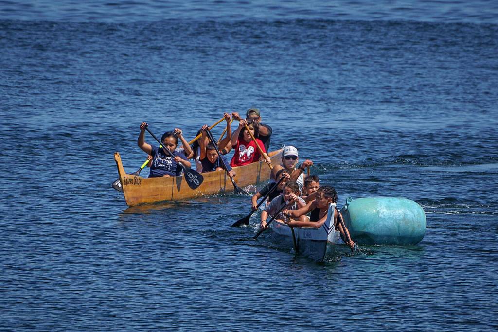 Photo by David Welton
Members of various Coast Salish tribes participate in canoe races at the Penn Cove Water Festival May 13. This years festival was the first since the beginning of the COVID-19 pandemic to hold the traditional canoe races.