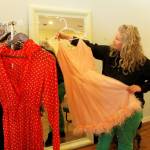 Photo by Kira Erickson/South Whidbey Record
Alison Donham holds up a dress from her rack of vintage prom dresses. Clients may be asked to model an outfit.