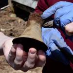 Photo by Patricia Guthrie
Woodhaven School freshman Alicia Jenkins shows off the metal bell she found to property owner Marian Myszkowski.