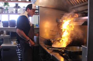 Photo by Karina Andrew/Whidbey News-Times
Ben Jones heats things up in the kitchen at Oystercatcher.