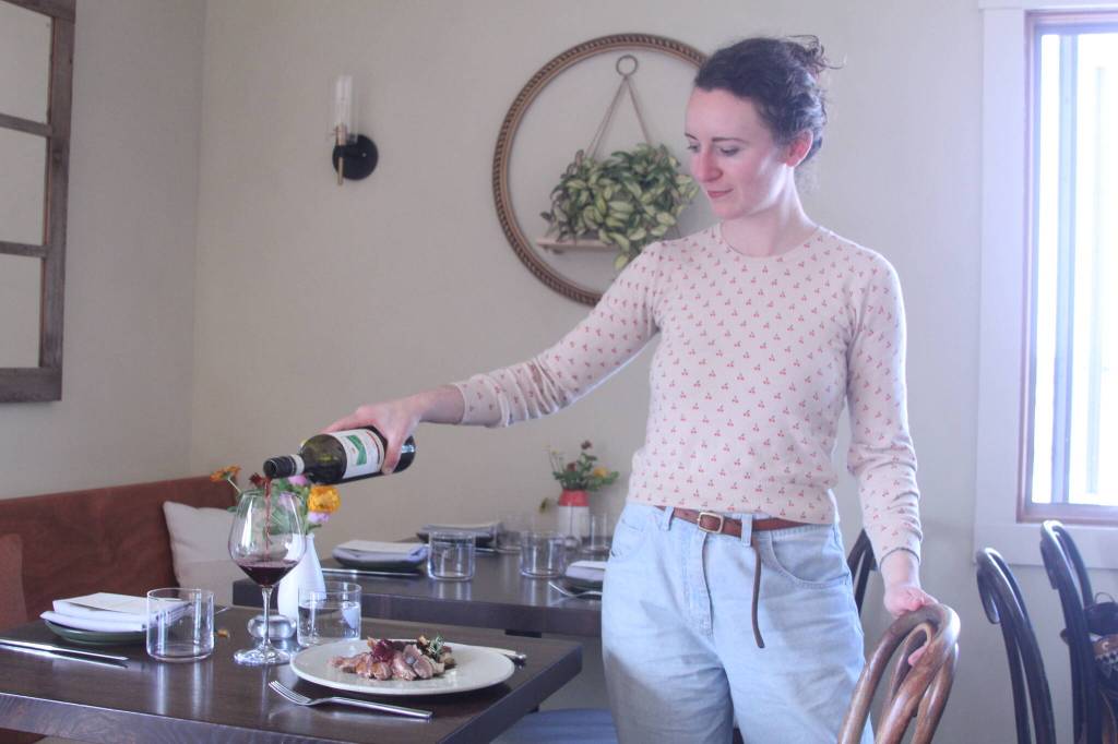 Photo by Karina Andrew/Whidbey News-Times
Sophia Kitay serves a meal and pours wine at Oystercatcher.