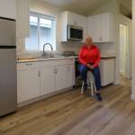 Hedlund sits in kitchen of a tiny house.