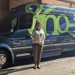 Sonia Gustafson stands in front of the current bookmobile. (Photo provided)