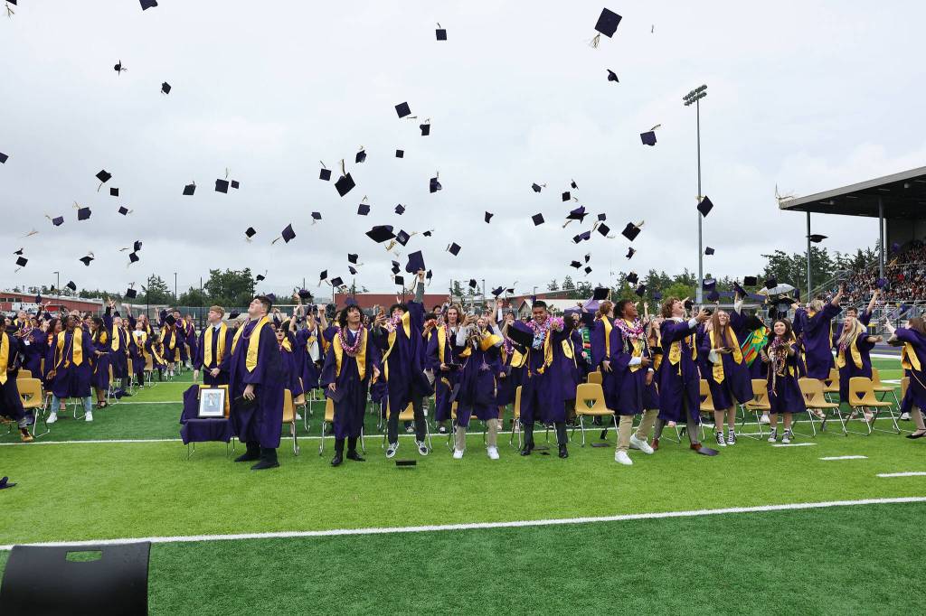 Oak Harbor High Schools class of 2023 toss their caps in the air following their commencement ceremony. (Photo by John Fisken)
