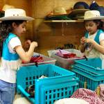 Second grader Athena Guerrero tries on accessories from the ranchs spacious closet. (Photo by David Welton)