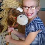 Second grader London Connell poses with a stick horse. (Photo by David Welton)
