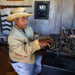 Fourth grader Marvin Rodriguez composes a message on an antique typewriter in the Cowboy Town jail. (Photo by David Welton)