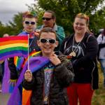 Conner Hampton, center, walks in the Coupeville Pride Parade with his brother, Corbin; his father, Larry; and his mother, Sara. (Photo by David Welton)