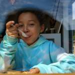 Thebe Madi, 9, digs into a piece of pie. (Photo by David Welton)