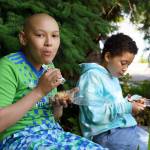 James Madi, 12, and Thebe Madi, 9, try some dessert from Whidbey Pies. (Photo by David Welton)
