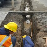 Public works crew members fix a leaky water main on Barrington Drive. (Photo provided)