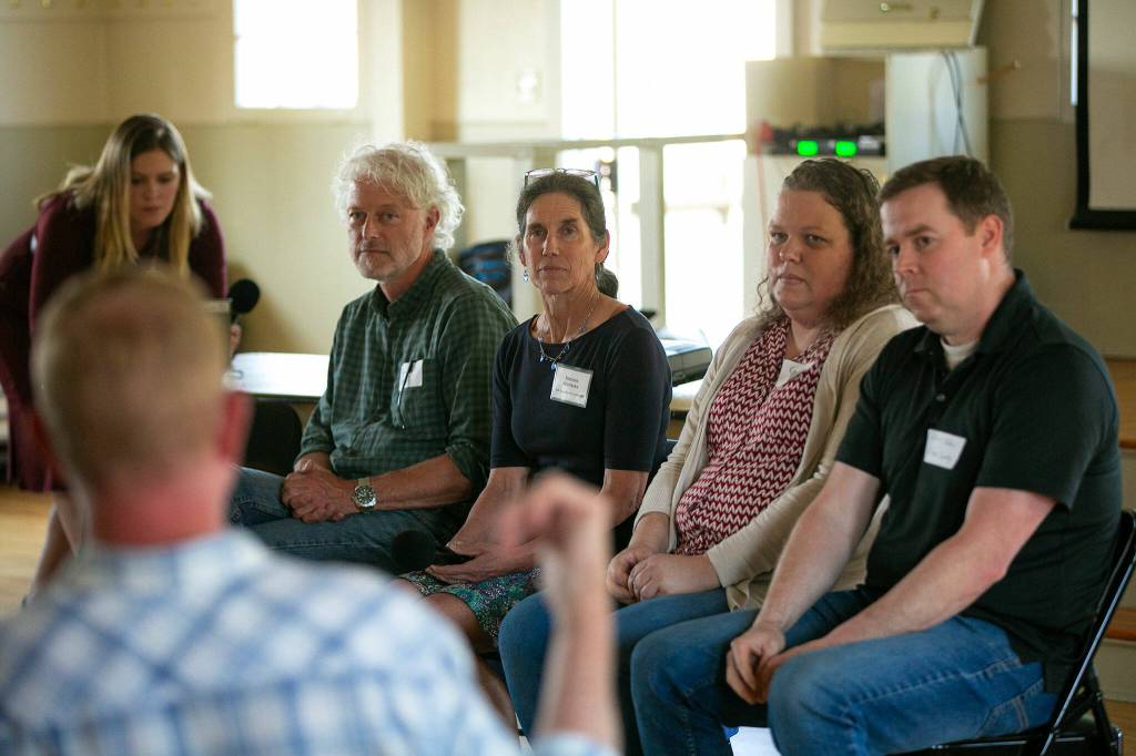 Representatives from different government organizations listen to a Harrington Lagoon resident speak about PFAS found in their drinking water during a public forum on June 22, 2023, at the Coupeville Recreation Hall in Coupeville, Washington. From left are Claire Nitsche of the Department of Health, DOH Regional Manager Derek Pell, DOH toxicologist Barbara Morrissey, Department of Ecologys Kim Wooten and Island County hydrogeologist Chris Kelley. (Ryan Berry / The Herald)